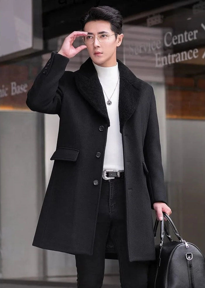 Men’s wool-cashmere coat with shearling peaked lapels in Onyx, model adjusting glasses while walking. From Borcelleclothes.