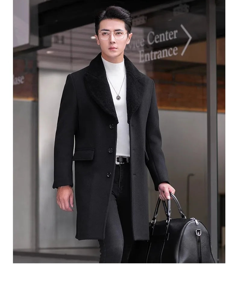 Men’s wool-cashmere coat with shearling peaked lapels in Onyx, model holding a black leather duffle bag. From Borcelleclothes.