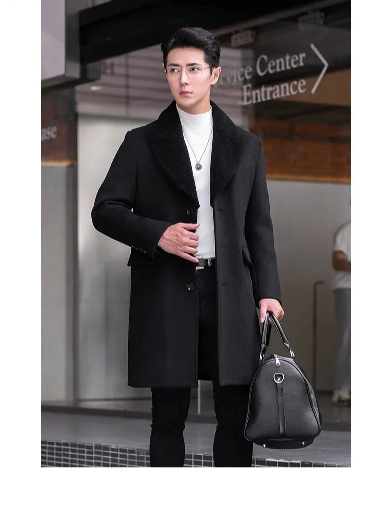 Men’s wool-cashmere coat with shearling peaked lapels in Onyx, model touching the front side of the coat. From Borcelleclothes.