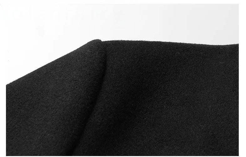 Men’s wool-cashmere coat with shearling peaked lapels in Onyx, close-up of the shoulder seam and texture. From Borcelleclothes.