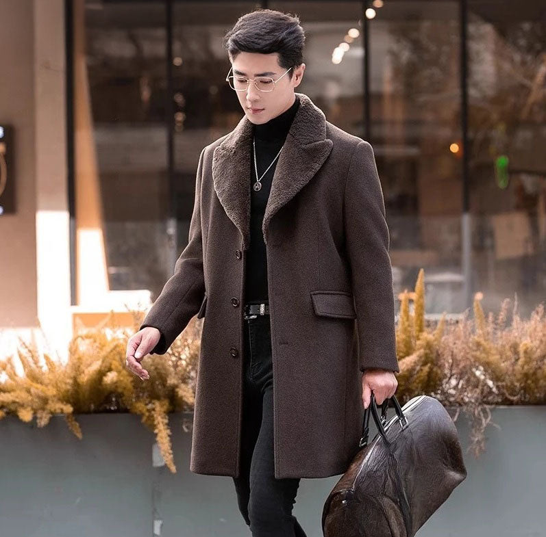 Men’s wool-cashmere coat with shearling peaked lapels in Wood Bark, model holding a brown leather duffle bag. From Borcelleclothes.