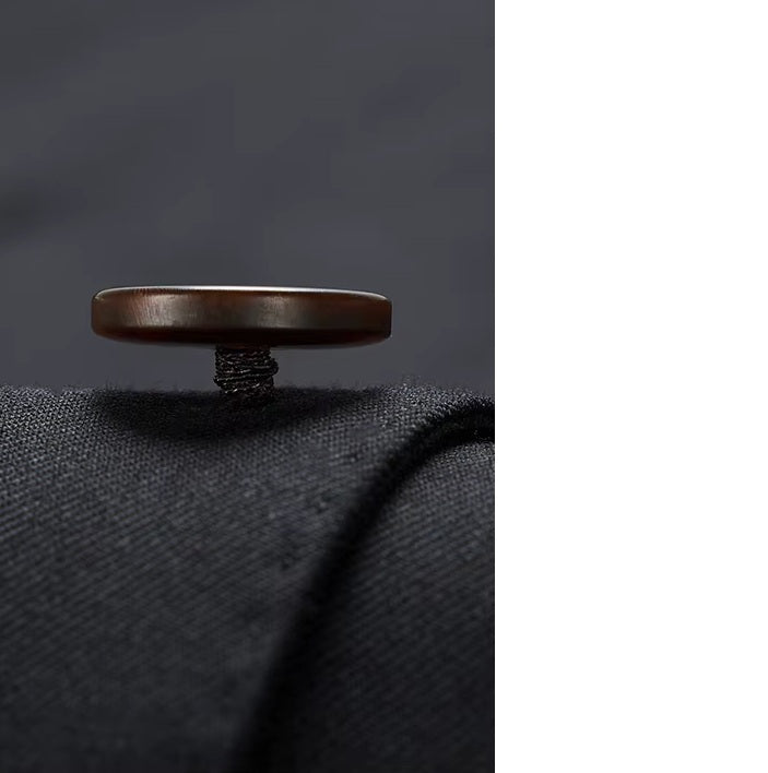 Blazer button from the Borcelleclothes Men's Wool and Silk Blend Suit in Onyx, featuring a meticulously crafted hand-sewn button shank, showcasing the refined artistry and functionality of the tailoring.