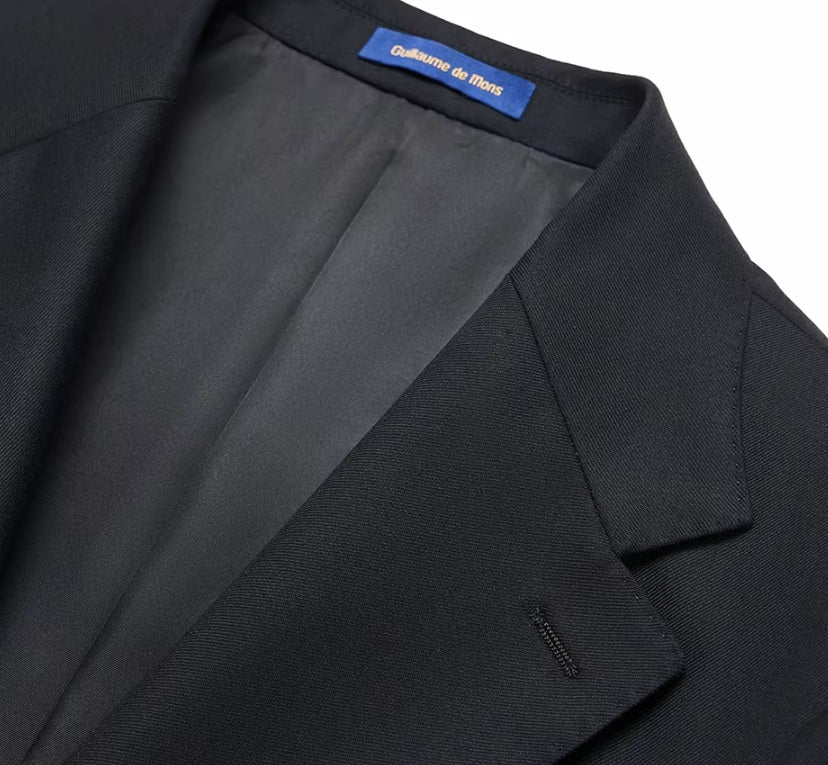 The blazer collar of the Borcelleclothes Men's Wool and Silk Blend Suit in Onyx Texture, showcasing the precision of the notch lapels and stitching.