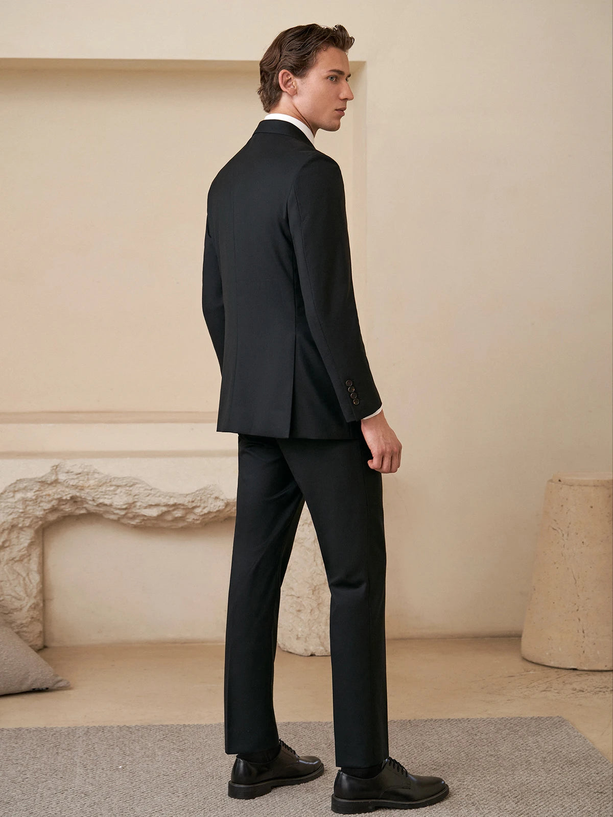 Back of the Borcelleclothes Men's Wool and Silk Blend Suit in Onyx Texture, highlighting the double-vent detail for enhanced mobility and style.