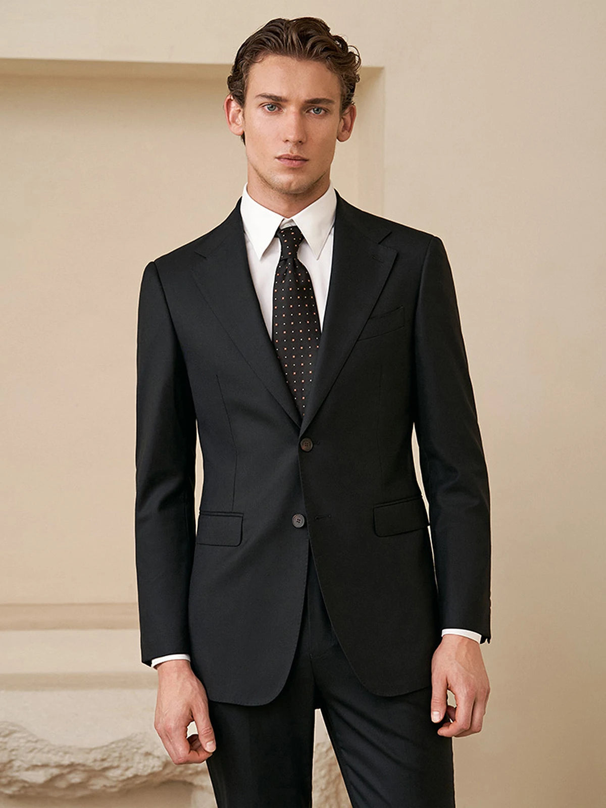 Model wearing the Borcelleclothes Men's Wool and Silk Blend Suit in Onyx Texture, gazing straight ahead, emphasizing the suit's refined elegance and confidence.