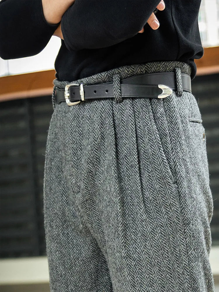 Man in Oslo Grey wool tweed trousers with arms crossed, exuding quiet confidence and timeless style. From Borcelleclothes.