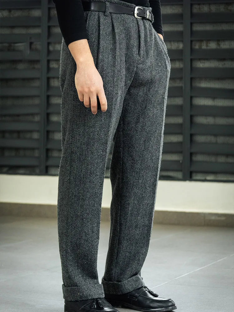 Side view of wide-leg wool tweed trousers in Oslo Grey, highlighting the silhouette and herringbone texture. From Borcelleclothes.