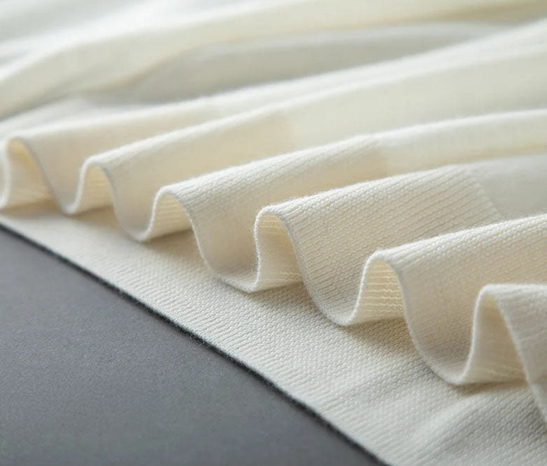 Bottom hem of the Platinum worsted cashmere sweater in 1×1 rib, completing the silhouette with refined balance — From Borcelleclothes.