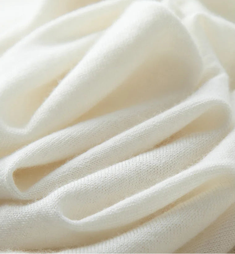 Men’s worsted cashmere crewneck sweater in Platinum, wave-folded to reveal the fine worsted texture and lightweight construction — From Borcelleclothes.