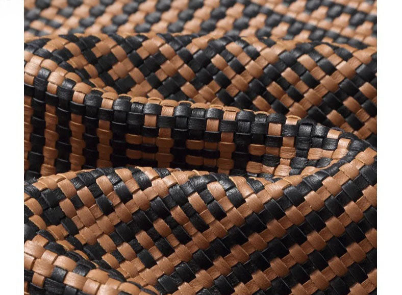 Close-up of woven-leather texture; interlaced sheepskin strips (French Beige & Onyx) — From Borcelleclothes.