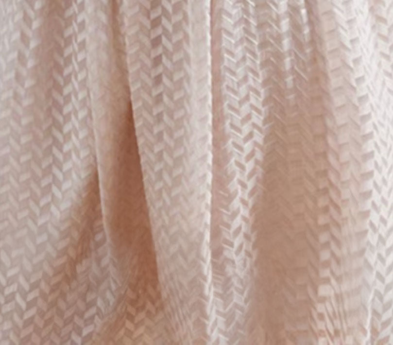Clam Shell-colored Mulberry silk georgette fabric softly draped, revealing the embossed geometric texture and its interplay of matte and sheen. From Borcelleclothes.