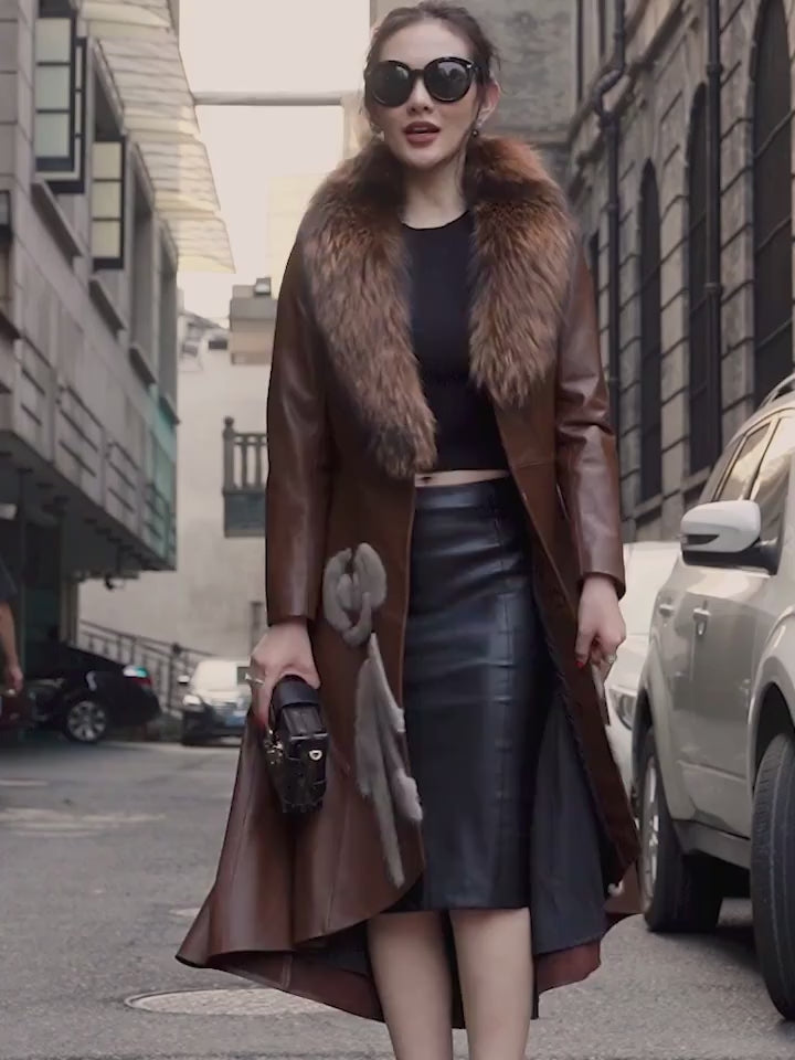 Video showcasing a Women's goatskin down coat in Irish Coffee and Onyx with a fox fur collar and mink fur appliqué. A sculptural high-low hem and flared design enhance its regal silhouette. Borcelleclothes.