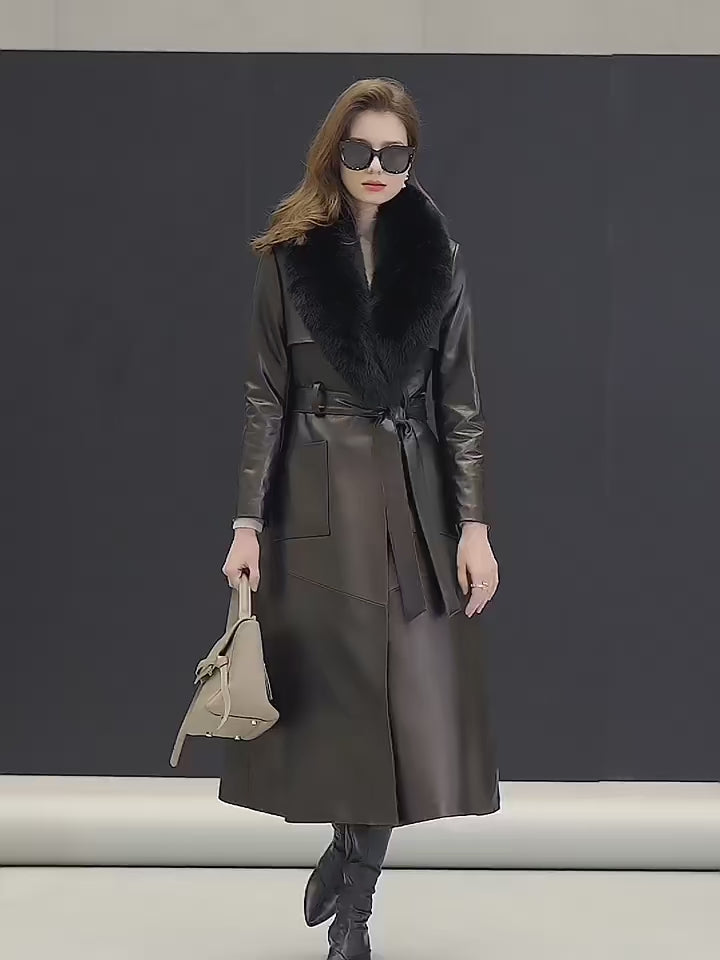 Video showcasing a Women's Leather Coat of Prestige in Nile Blue and Onyx. A mid-calf wrap coat crafted from sumptuous sheepskin, designed for effortless elegance and quiet confidence. Featuring a structured yet fluid silhouette, notch lapels, a detachable fox fur collar, and refined patch pockets. A statement of poise and authority. Borcelleclothes.