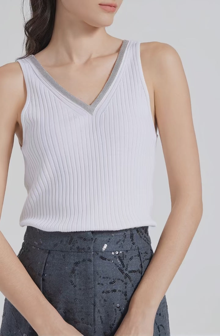 Video showcasing a Women’s slim-fit wide-rib wool and silk top in White Lilac with front and back V-necklines and delicate rhinestone fringe at the front. From Borcelleclothes.