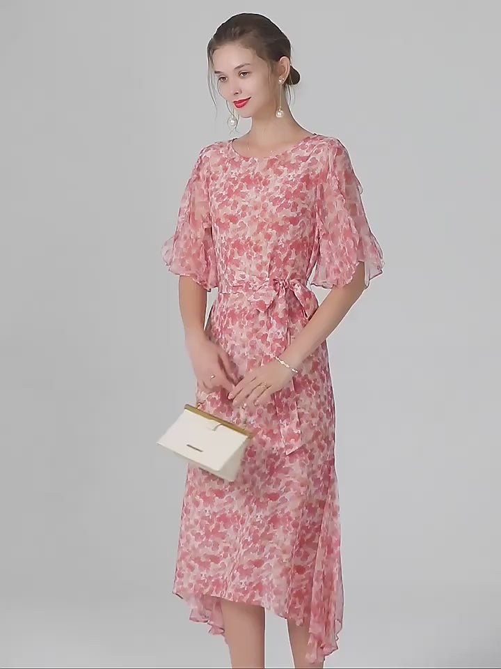 Video showcasing a Mulberry silk chiffon dress with abstract floral print in rose tones, featuring a round neckline, matching belt, and softly flowing volume. From Borcelleclothes.