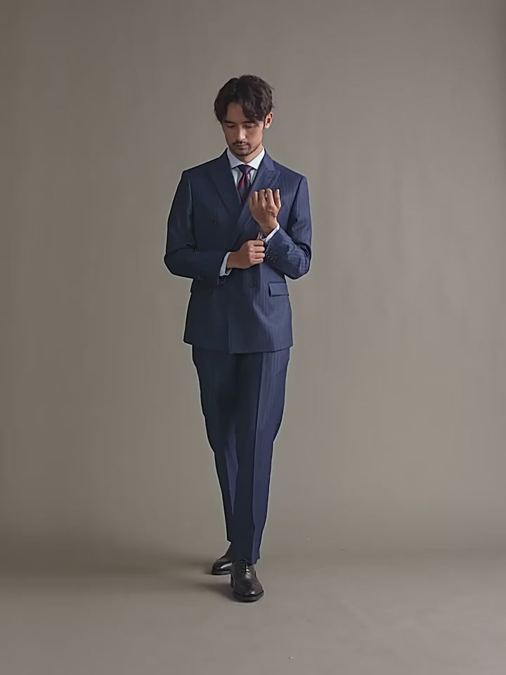 Video showcasing a Men's Lucky Point Pinstripe Suit in deep blue, featuring a double-breasted blazer with peaked lapels, six-button design, and pinstripe pattern, paired with straight-cut trousers and an optional single-breasted vest for a refined and versatile look. From Borcelleclothes.