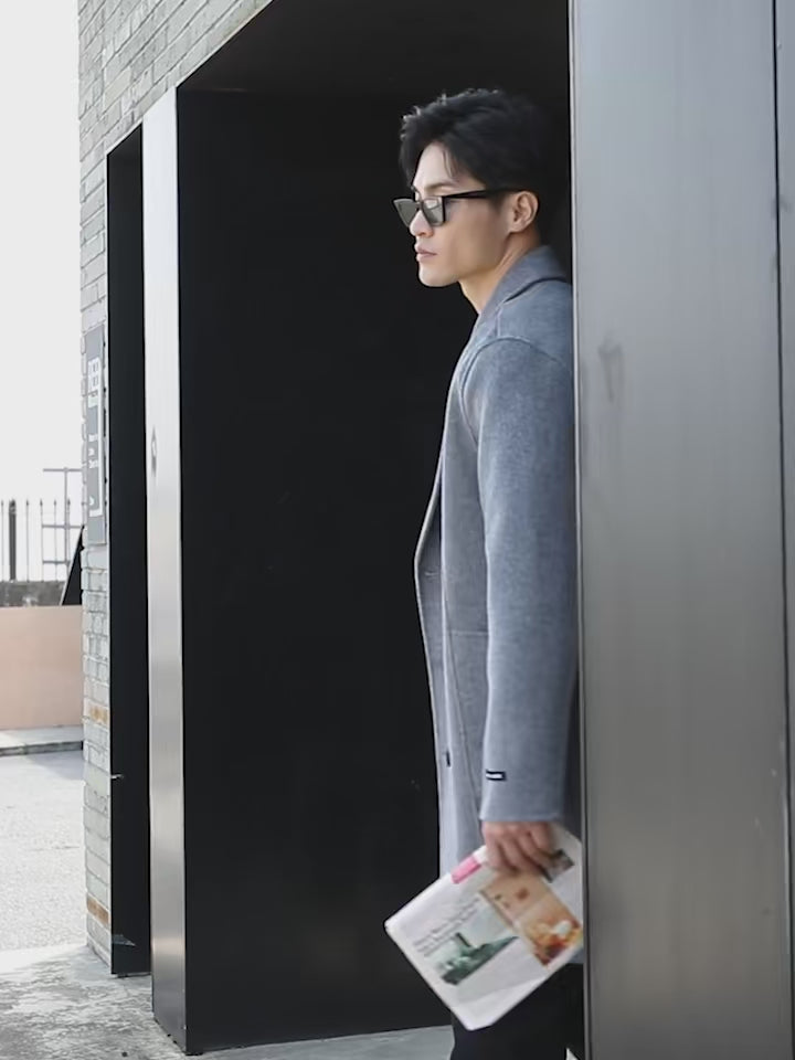 Video showcasing a Men’s Double-Sided Wool Coat in Comet—crafted from 100% wool with a structured, double-breasted silhouette. Featuring six buttons, notch lapels, patch pockets, and a clean, unlined interior for lightweight warmth and everyday confidence. From Borcelleclothes.