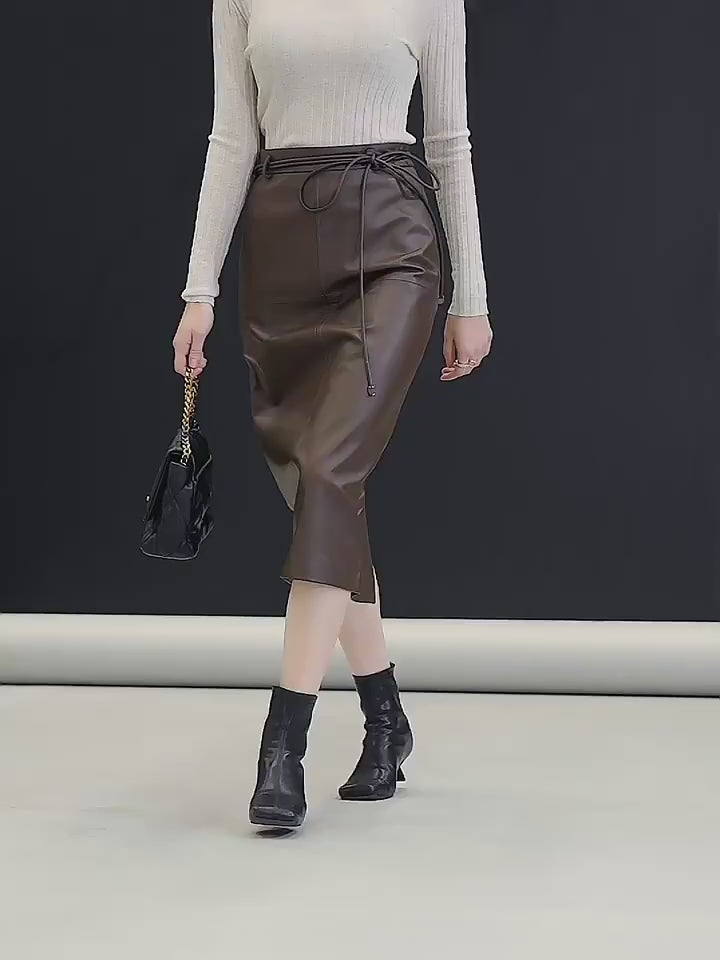 Video showcasing a Women’s sheepskin midi skirt in Dark Rum — a straight silhouette in genuine leather with an extended tie waist, central back vent, and mid-calf length, crafted for quiet structure and poised movement. From Borcelleclothes.