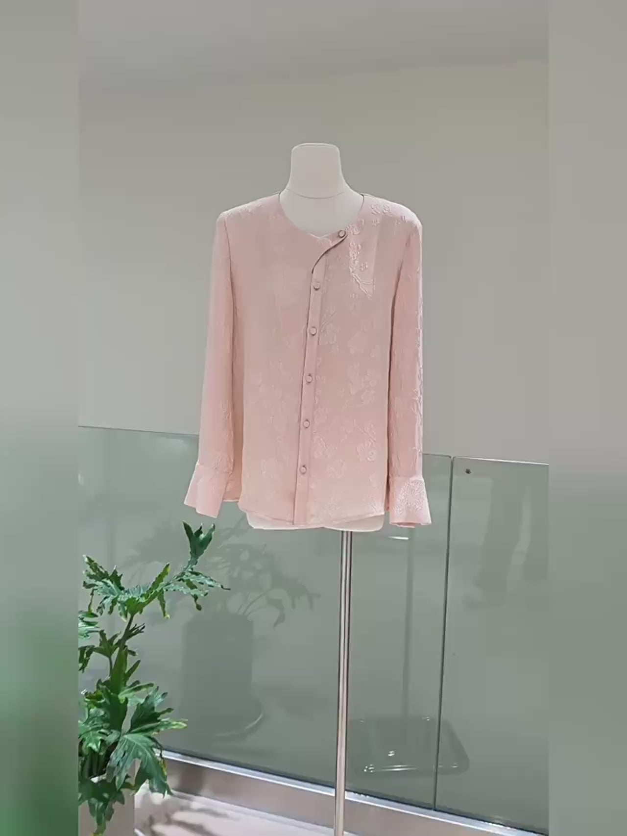 Video showcasing a Women's jacquard silk blouse in three colors with curved placket, fabric-covered buttons, and stepped cuffs. From Borcelleclothes.
