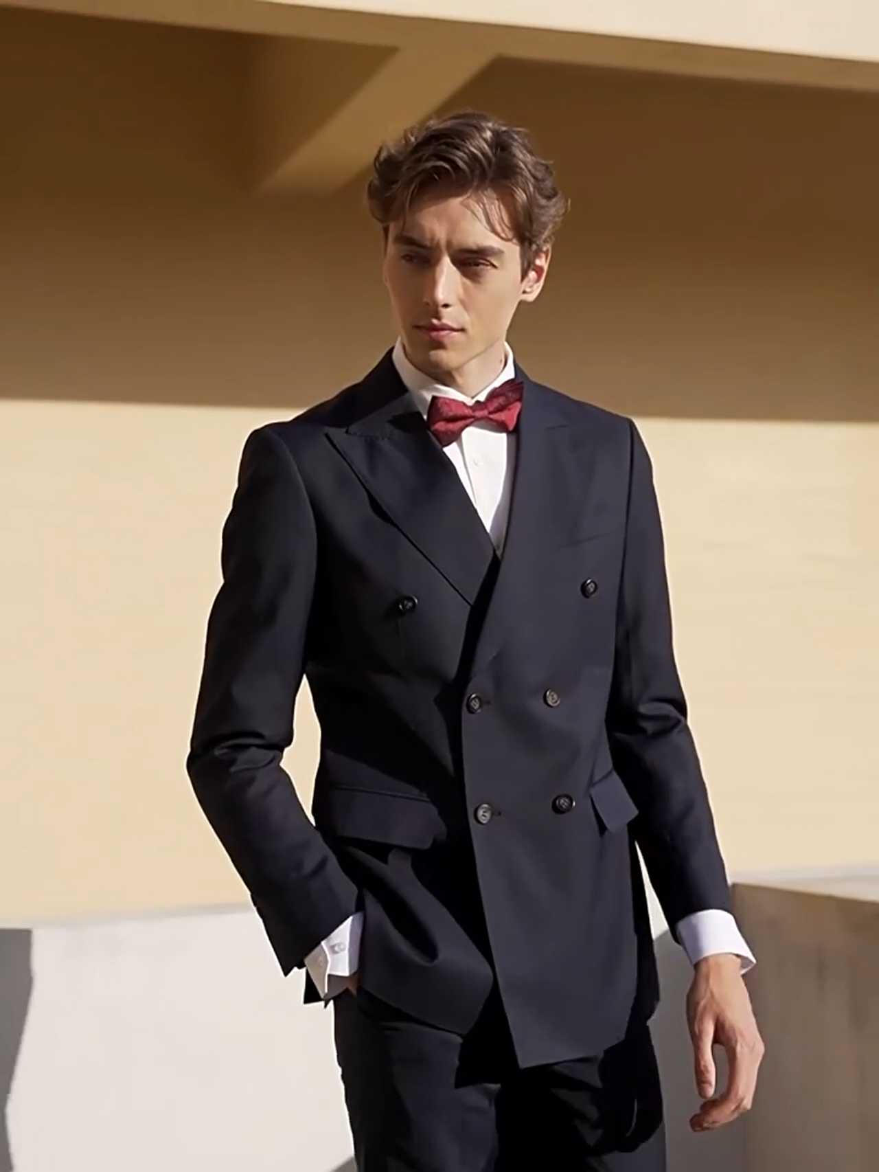 Video showcasing a Men’s formal double-breasted wool suit in Ebony Clay with peaked lapels and four-button sleeve plackets — structured, composed, and quietly commanding. From Borcelleclothes.