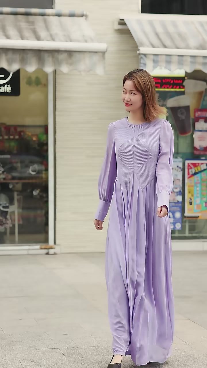 Video showcasing a Women's silk georgette dress in Cold Purple featuring sculptural tuck-panel bodice with vest illusion and softly pleated skirt. From Borcelleclothes.