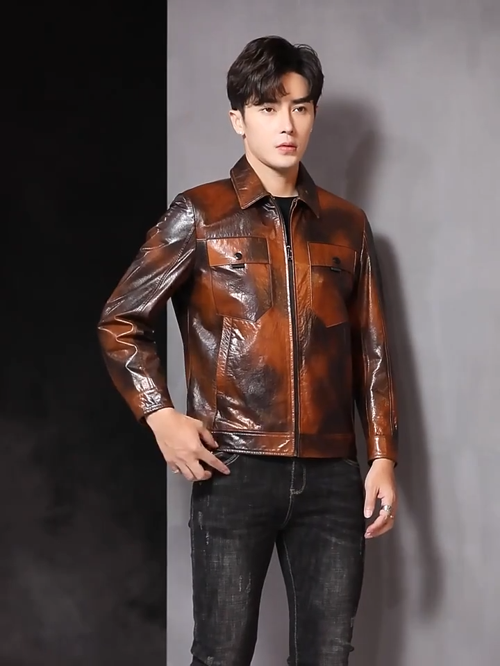 Video showcasing a Men's Mottled cowhide leather jacket with pointed collar, chest flap pockets, snap cuffs, and hem band; quiet warmth before it’s named. From Borcelleclothes.