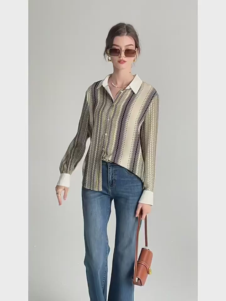 Video showcasing a Women's 3D geometric silk shirt with orange, deep blue, and soft yellow stripes, featuring a cream collar and matching cuffs. From Borcelleclothes.