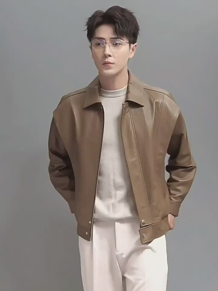 Video showcasing a Men’s goatskin leather jacket in Sandrift with front and back flaps; crafted for a structured yet supple silhouette with layered design, subtle sheen, and modern, intuitive lines. From Borcelleclothes.