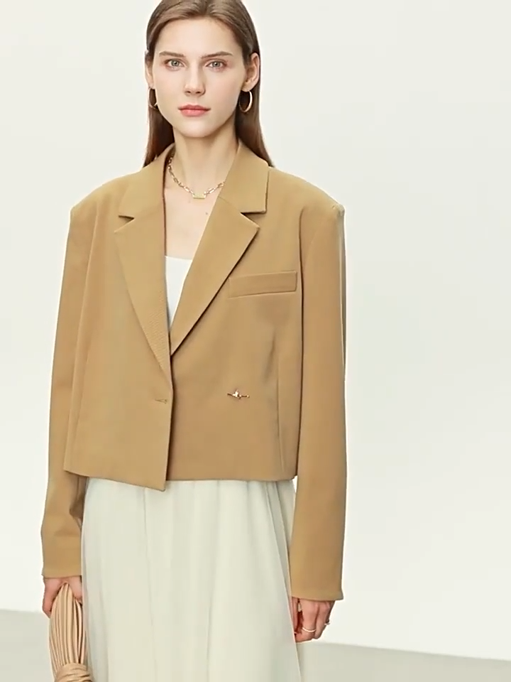 Video showcasing a Women’s Wire Knot Detail Blazer in French Beige and Onyx, with notch lapels, decorative wire-knot buttons, and precise tailoring. From Borcelleclothes.