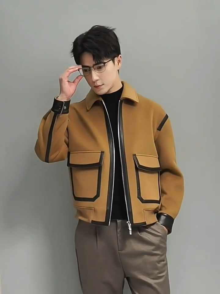 Video showcasing a Men's Wool-and-cashmere jacket in Lion,  with leather trims, large patch pockets, and ribbed hem integrated into sides and back — from Borcelleclothes.