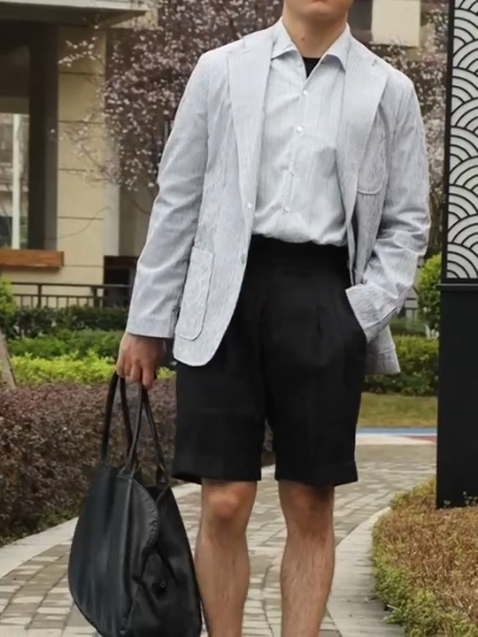 Video showcasing tailored men's shorts in deep onyx linen, featuring a clean front, structured silhouette, and sharp tailoring for warm-weather refinement. From Borcelleclothes.