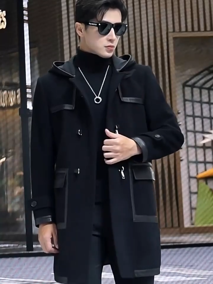 Video showcasing a Men’s hybrid wool-leather coat in Onyx, with hood, leather overlays, and distinctive swivel-clasp closures. From Borcelleclothes.