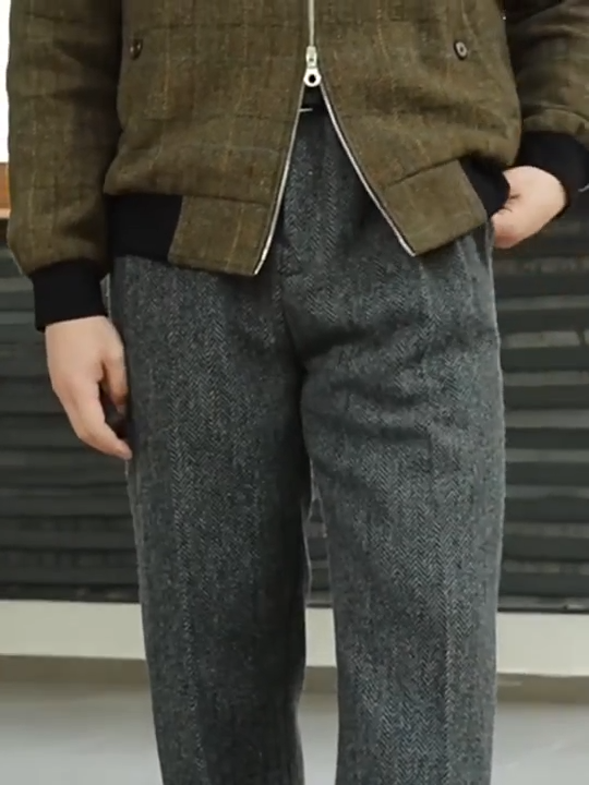 Video showcasing a Men's wide-leg wool tweed trousers in Oslo Grey, featuring four front pleats and turned-back cuffs for a tailored, heritage-inspired silhouette. From Borcelleclothes.