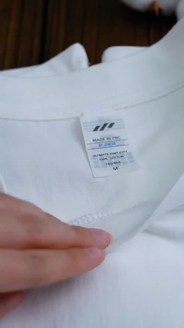 Video showcasing a Women's Mid-Weight Cotton T-Shirt in White, featuring a slightly oversized fit, classic crew neck, and short sleeves. Made from cozy, mid-weight fabric, this t-shirt offers comfort and versatility, perfect for cooler days and casual styling. Available in 10 colors. From Borcelleclothes.