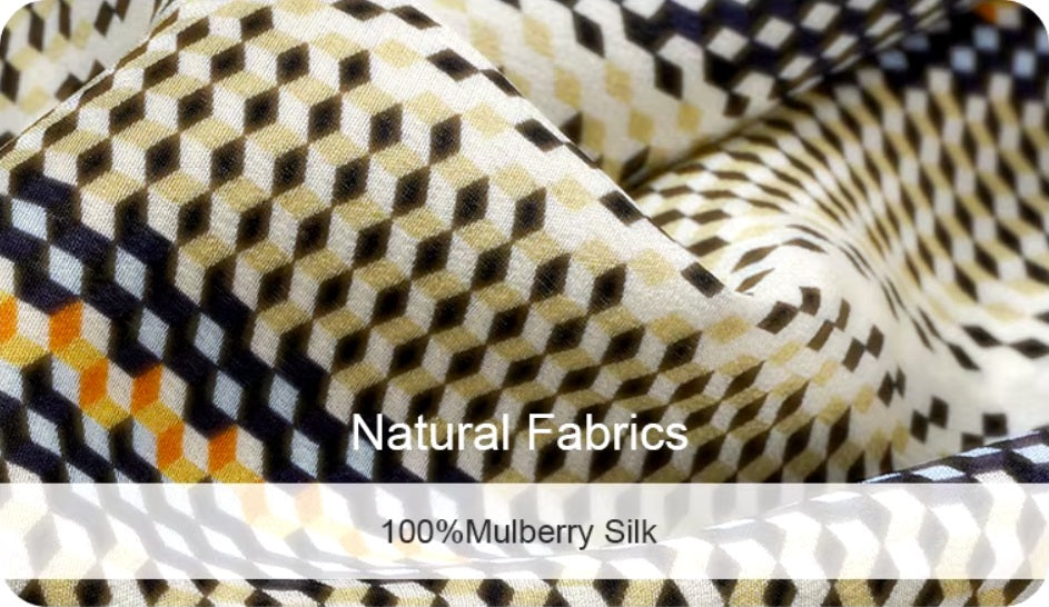 Demo of 100% Mulberry Silk fabric showcasing the intricate 3D geometric stripe pattern in orange, blue, and yellow, highlighting the fabric’s luxurious texture and design. From Borcelleclothes.