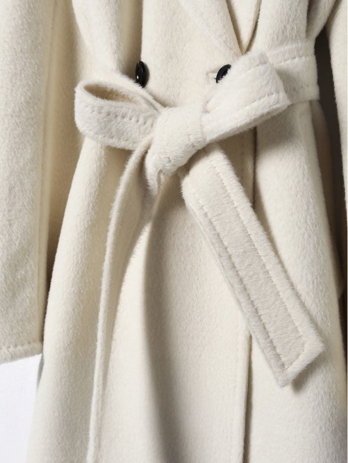 Women’s Mid-Calf Alpaca Coat in Orchid White with a belted bow, emphasizing its elegant tailoring and luxurious Suri alpaca texture. From Borcelleclothes.