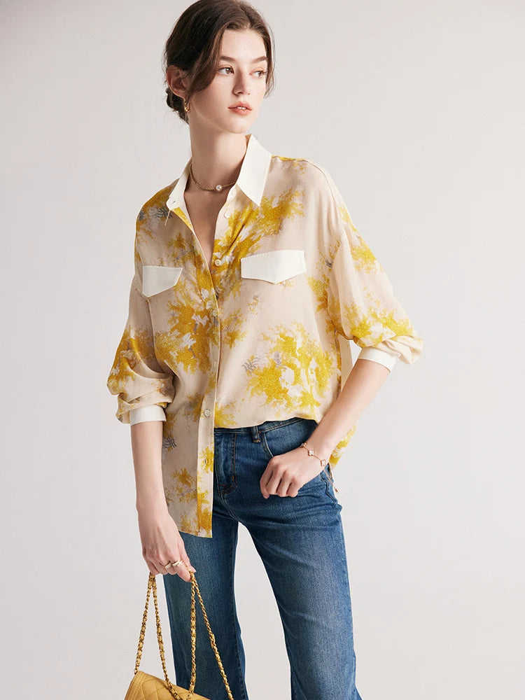 Model holding a bag, wearing women's 100% Mulberry Silk Mimosa Print Shirt. From Borcelleclothes.