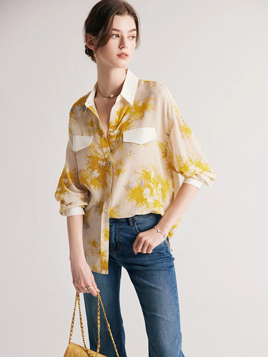 Model holding a bag, wearing women's 100% Mulberry Silk Mimosa Print Shirt. From Borcelleclothes.
