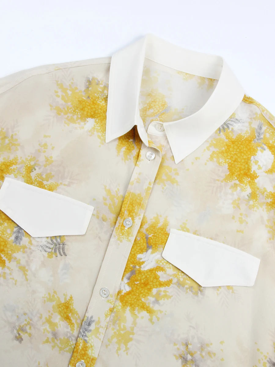Detailed stitching and textured fabric on the contrast collar and contrast flaps of a Women's 100% Mulberry Silk Shirt with Mimosa Print in Dawn Pink, featuring contrast collar, bold accents, and a flowing silhouette. From Borcelleclothes.