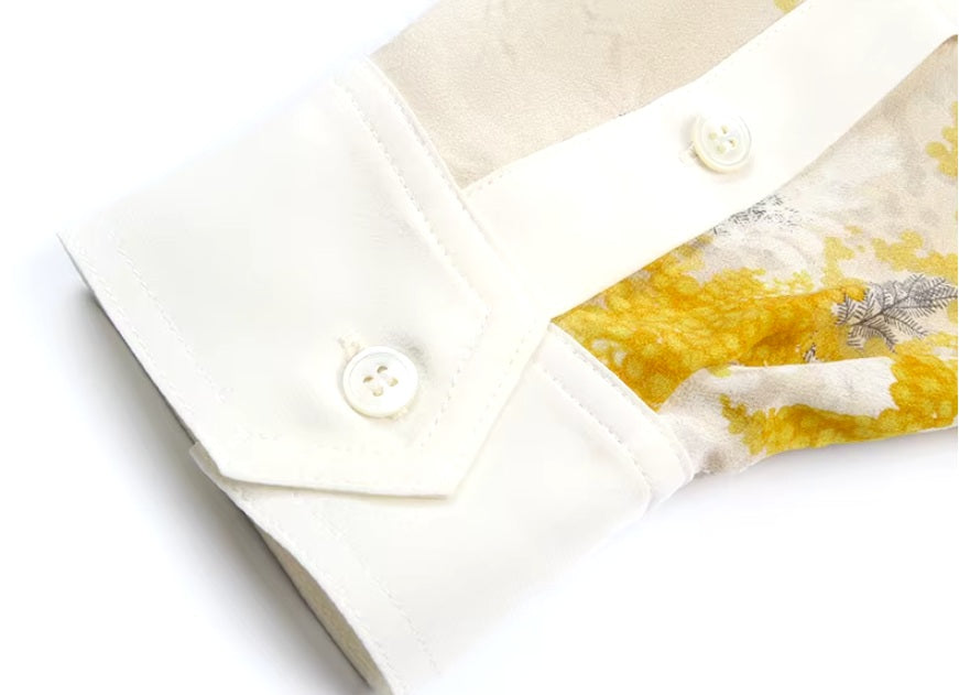 Detailed stitching and textured fabric on the contrast angled cuff of a Women's 100% Mulberry Silk Shirt with Mimosa Print in Dawn Pink, featuring contrast collar, bold accents, and a flowing silhouette. From Borcelleclothes.