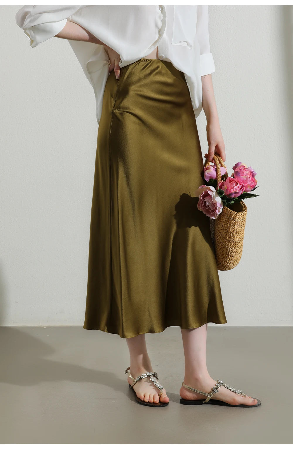 Model’s hand resting on ribbed waistline of the Himalaya silk skirt, showing texture and detail. From Borcelleclothes.