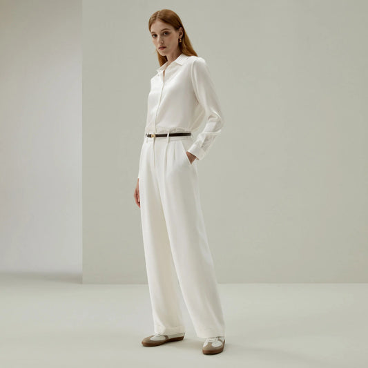Model wearing Pearl Bush 40 Momme silk trousers, hand in pocket — a moment of quiet structure and poised ease. From Borcelleclothes.