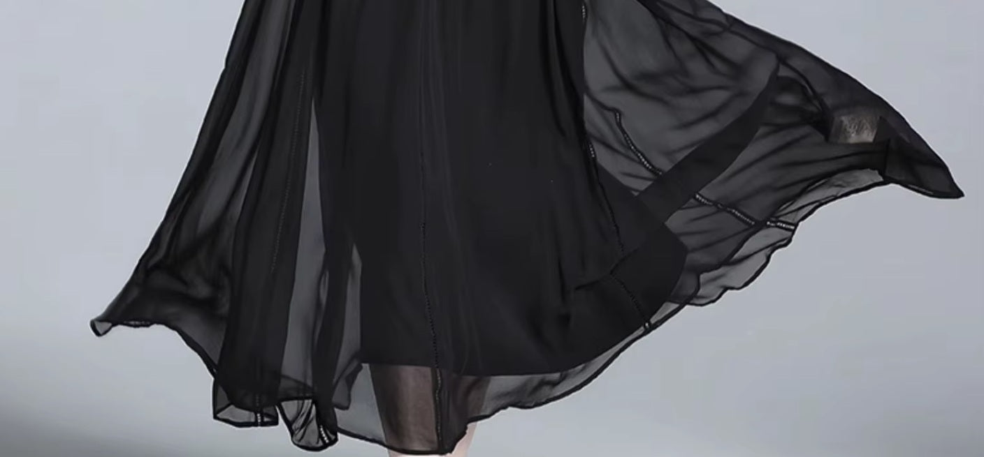 Flowing hemline of black silk georgette dress, mid-length view. From Borcelleclothes.