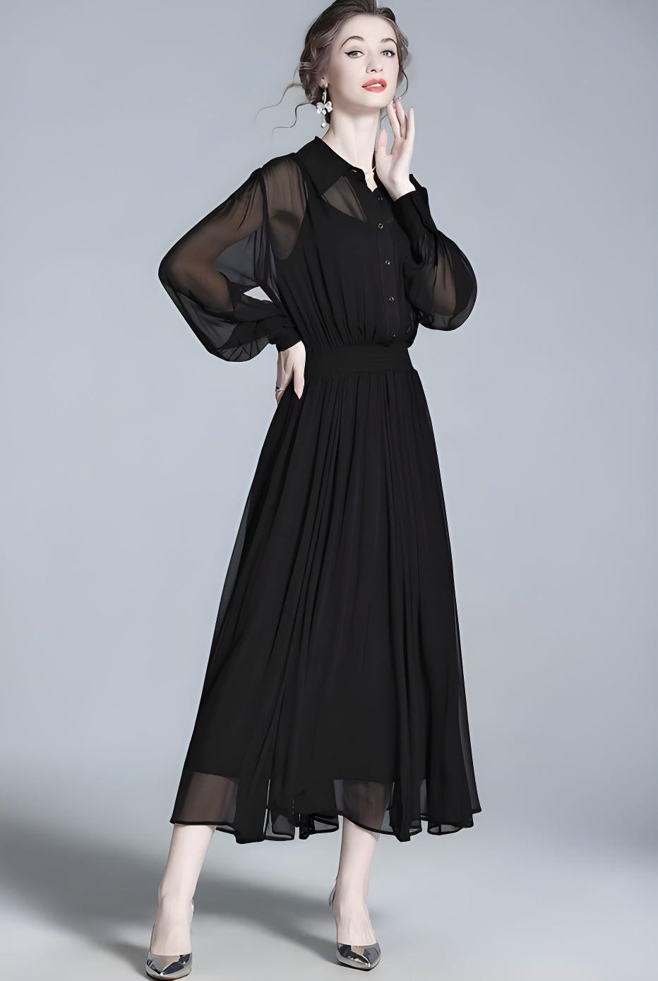 Model wearing black silk georgette dress, gently touching her face. From Borcelleclothes.