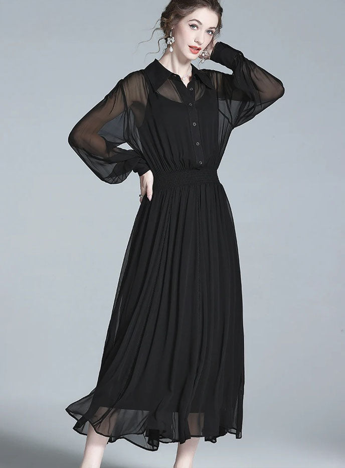 Model in black silk dress, casually touching her hair. From Borcelleclothes.