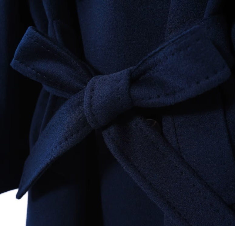 The adjustable waist belt tied in a bow on the Women's 7/8 Cashmere Blend Coat in Deep Cove, highlighting its versatility and feminine touch. From Borcelleclothes.