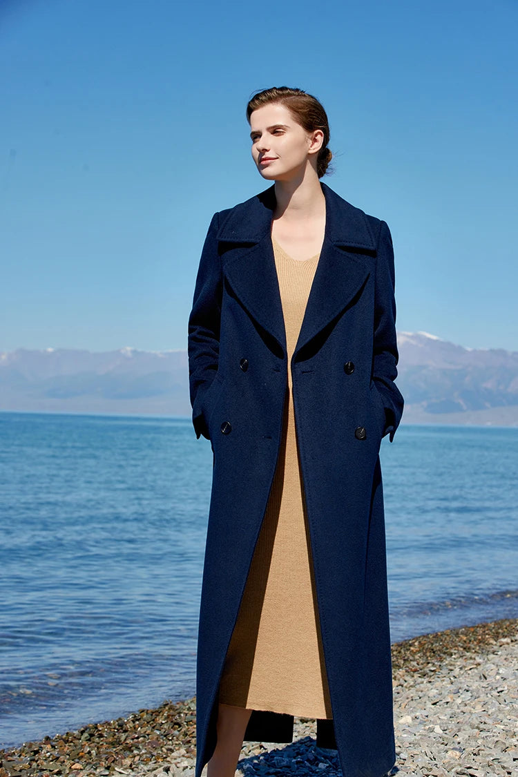 Model in the Women's 7/8 Cashmere Blend Coat in Deep Cove with hands in the single-welt pockets, highlighting its refined design and functionality. From Borcelleclothes.