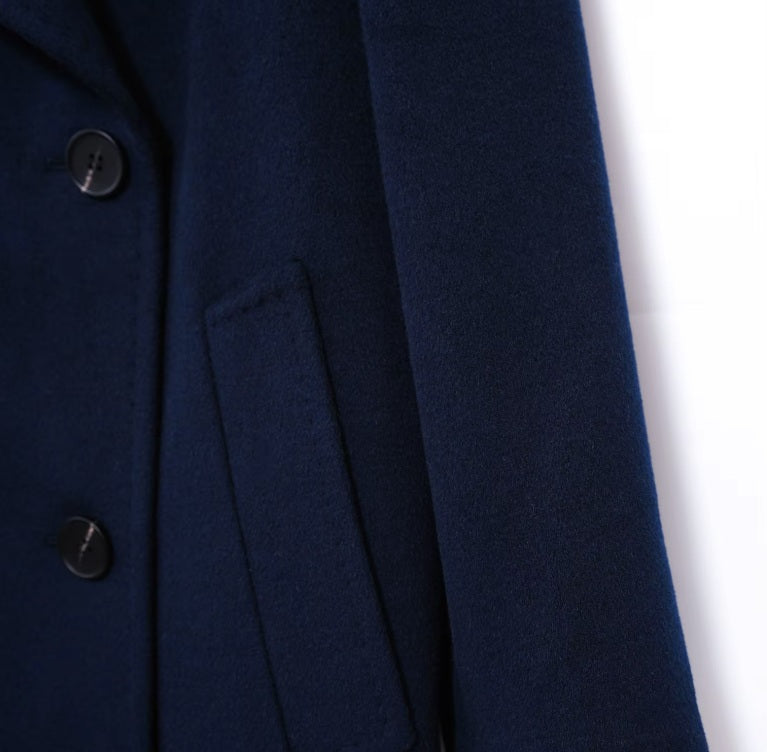 The diagonally exposed single-welt pocket on the Women's 7/8 Cashmere Blend Coat in Deep Cove, showcasing its elegant and functional design. From Borcelleclothes.