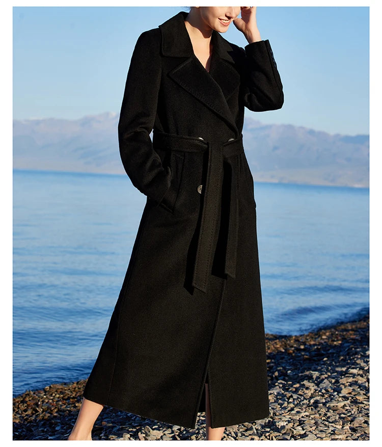 Model wearing the Women's 7/8 Cashmere Blend Coat in Onyx, slightly turned to the side, emphasizing its sleek silhouette and versatile elegance. From Borcelleclothes.