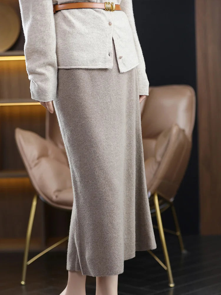 A-line merino wool skirt in Warm Grey, model turned slightly left, showing the calm A-line drape — From Borcelleclothes.